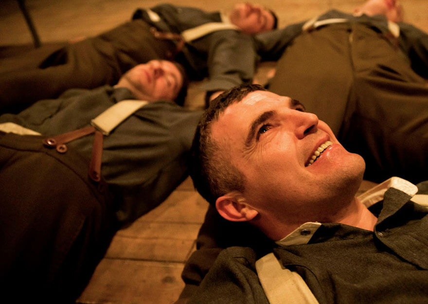 sailors lie on stage floor as part of anu productions show pals