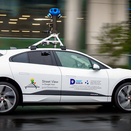 aclima air quality monitoring sensor sits on top of white electric street view car