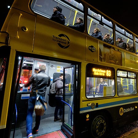 man pays fare on dublin bus getting to college at night