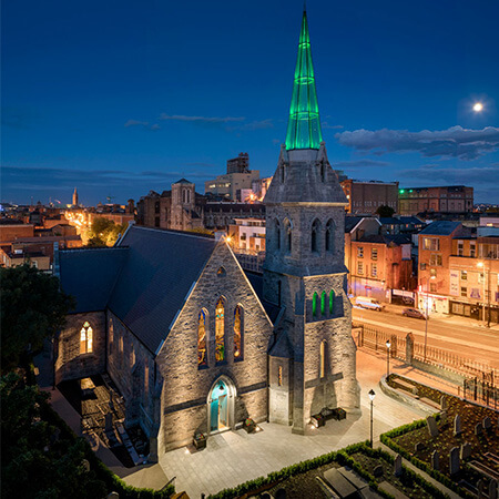 pearse lyons distillery and its glass steeple lit up at night