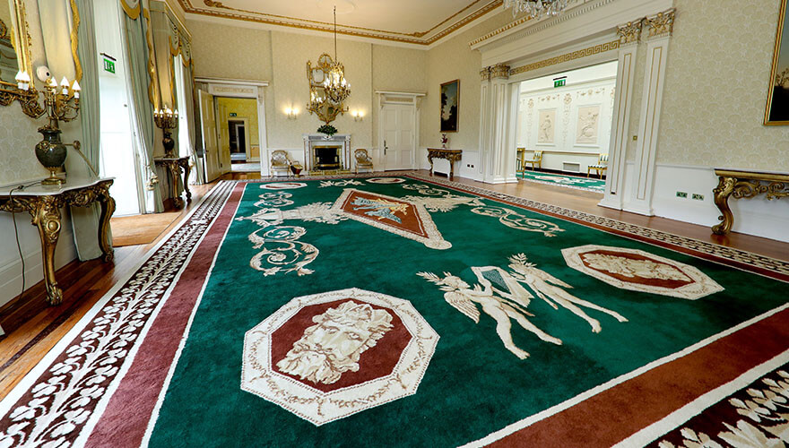 highly decorated red and green rug at Áras an Uachtaráin