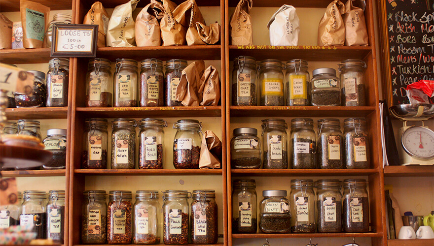 Shelves packed with tea-leaf jars and packets