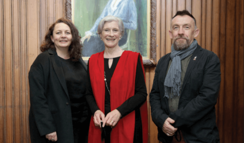 abbey theatre directors stand in front of painting of a woman